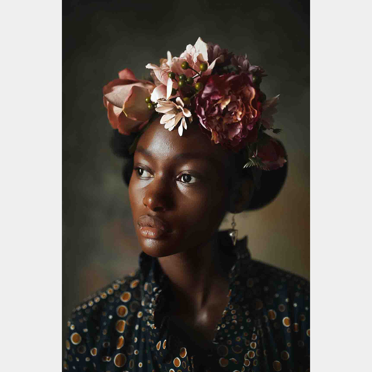 A Black woman wearing a flower crown