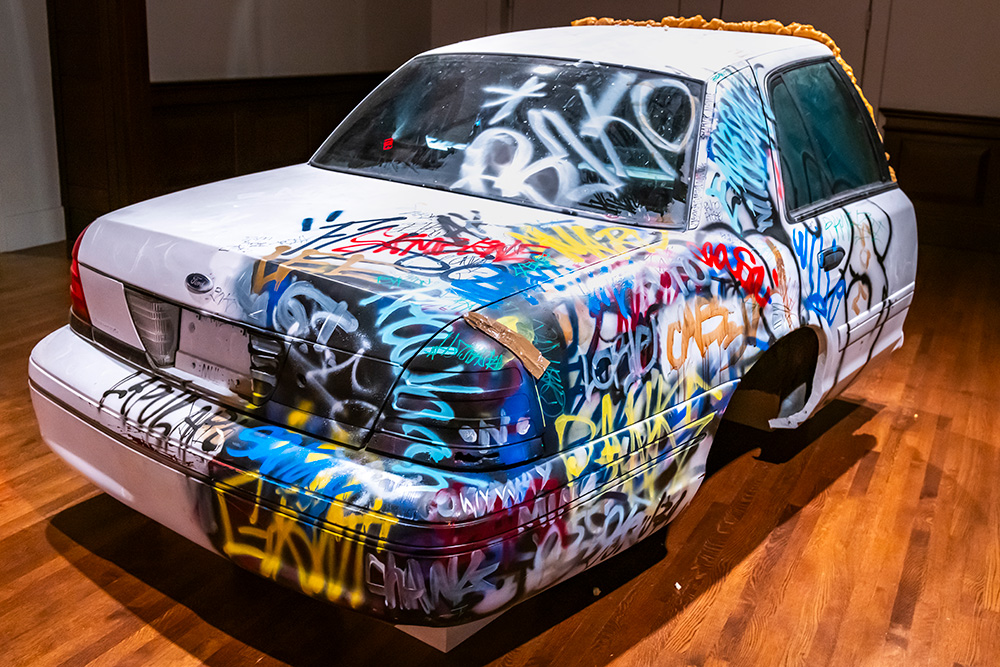 Half of a car covered with graffiti