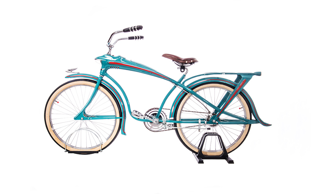 A bicycle with a sleek, curving turquoise frame