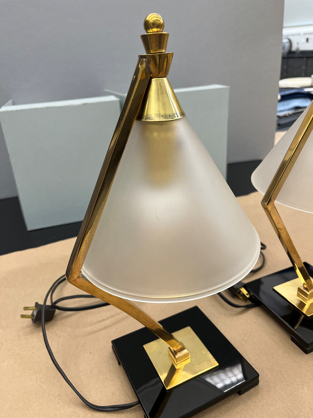 A closer look at one of the lamps, showing dark smudging at the bottom of the gold metal