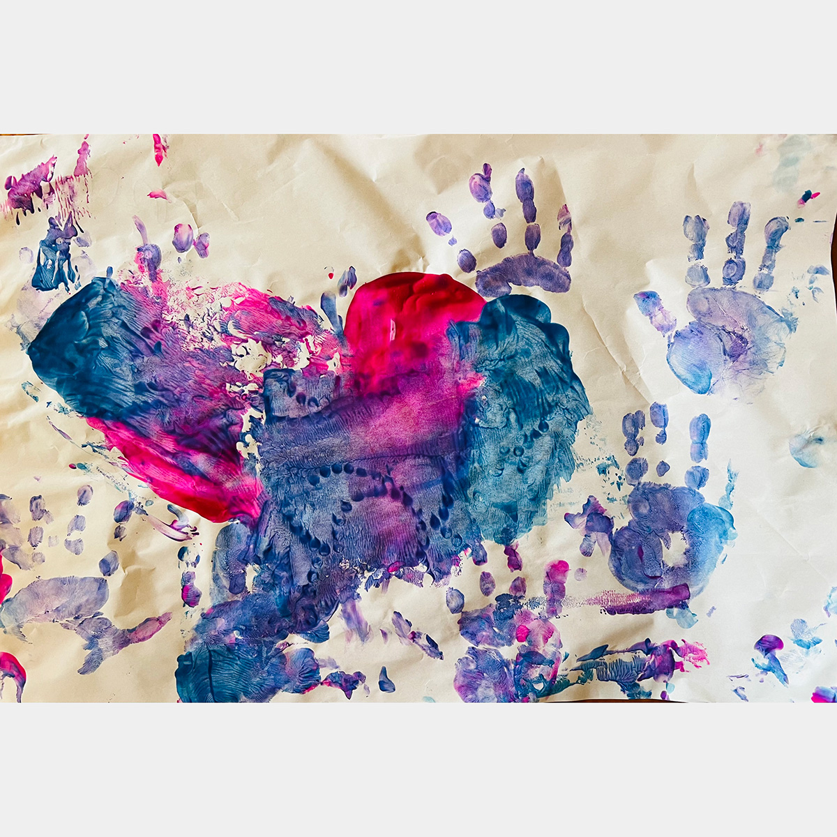 A colorful kid's hand painting in blue, red and purple