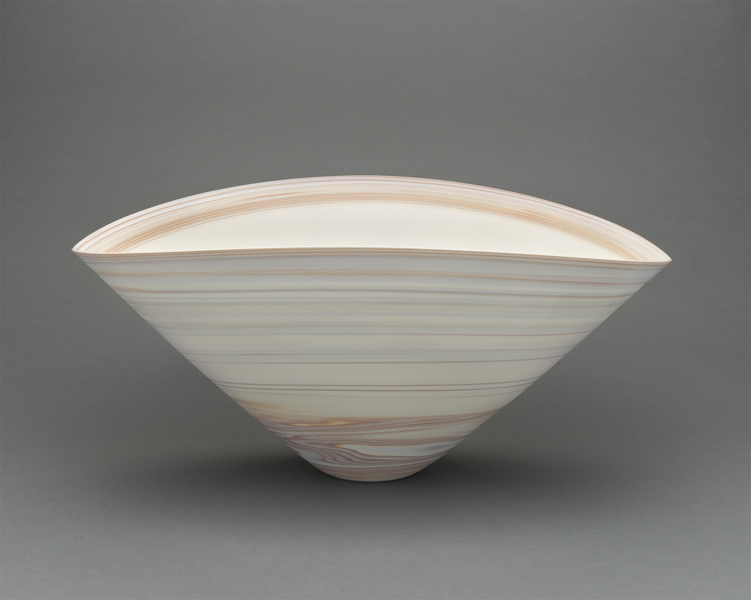 a light-colored bowl with a triangular shape