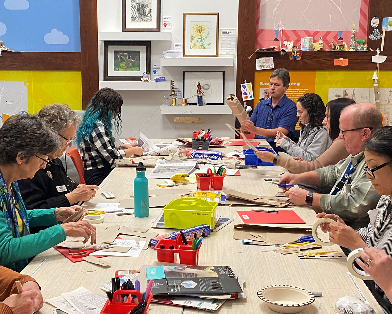A large group of adults makes art in the REC