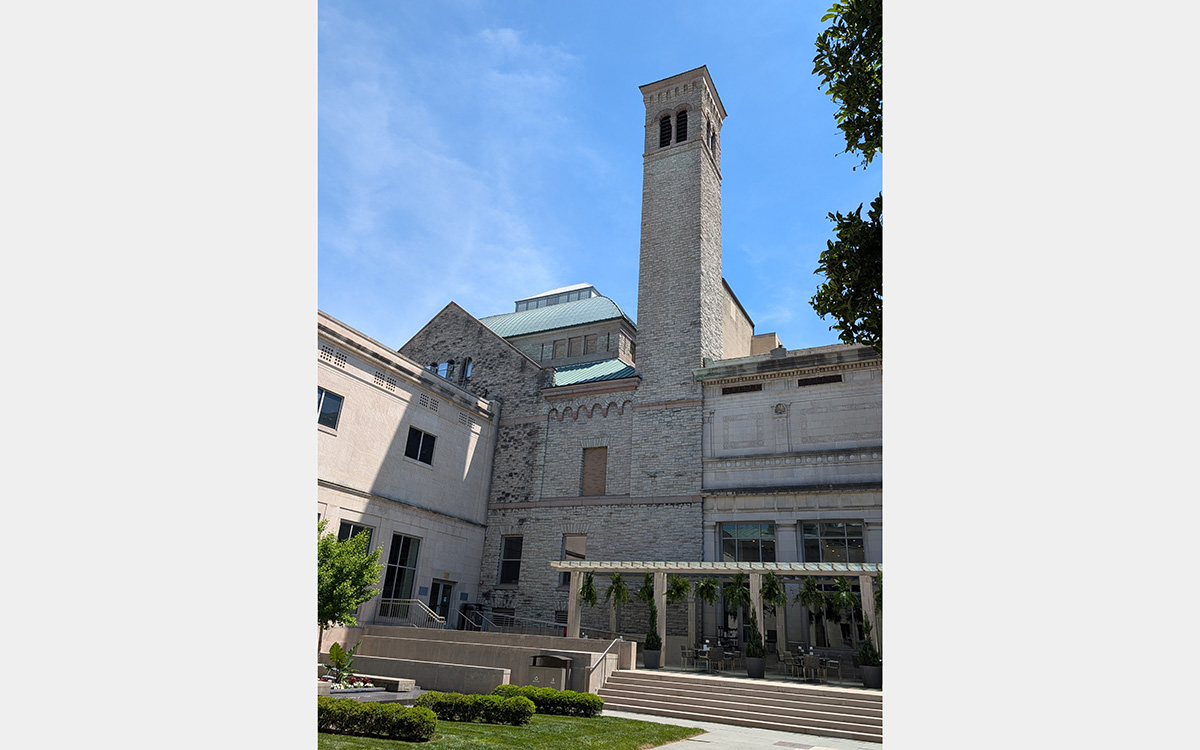 Courtyard view of a stone building with tower