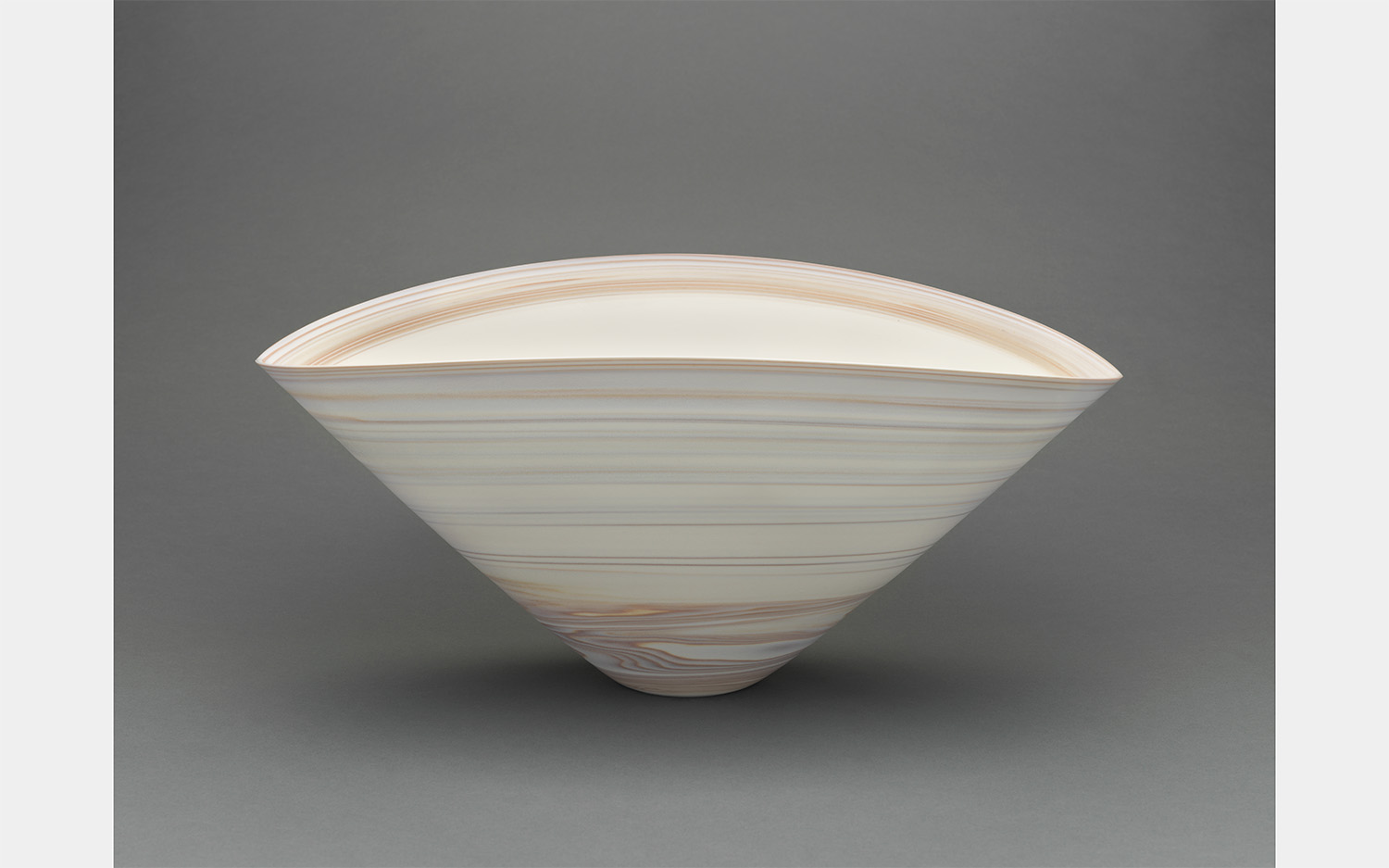 a light-colored bowl with a triangular shape