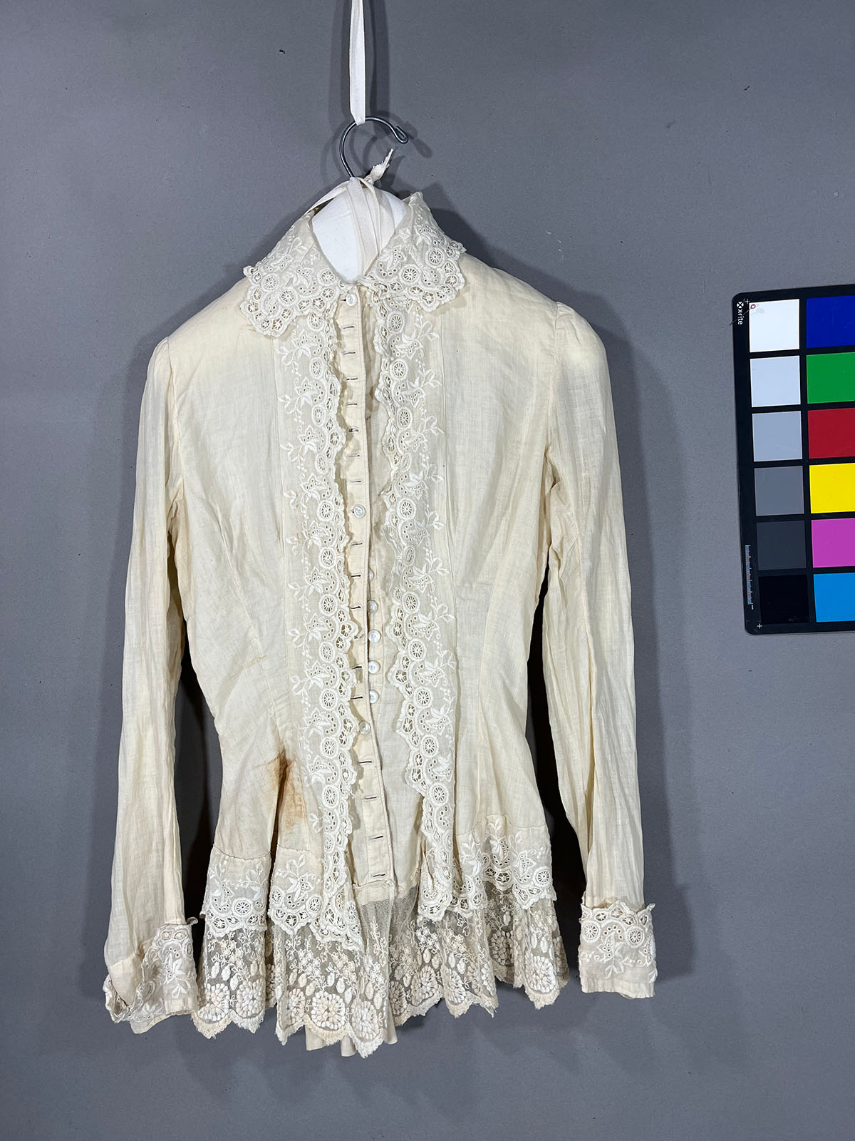 An intricate white blouse with yellowed color