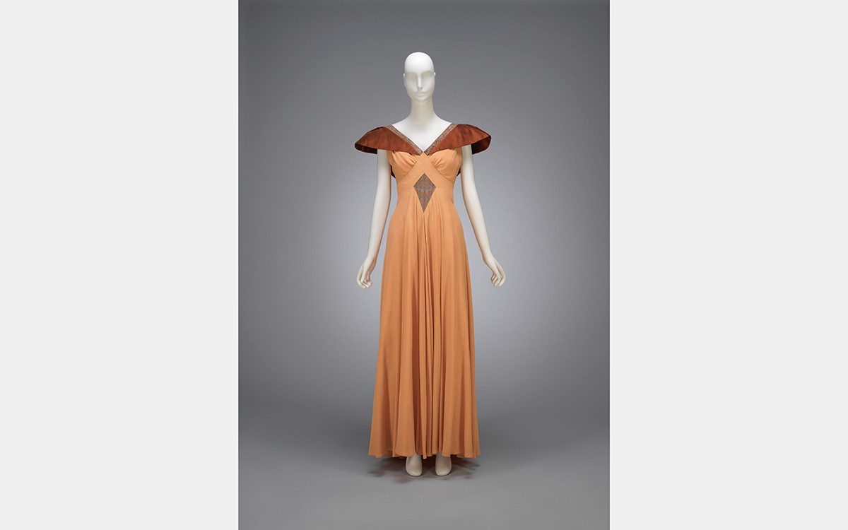A warm orange gown with dark orange shoulder details