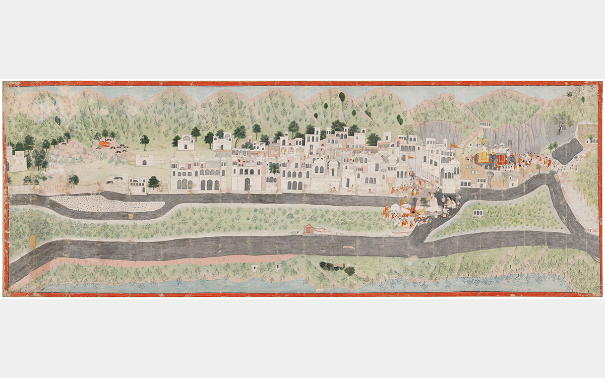 A town with white buildings set against a mountainous landscape with two groups of the people and an elephant.