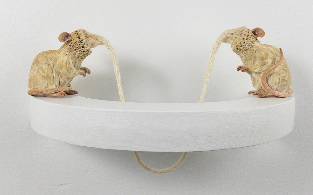 Two mice connected by a knitted, dangling string