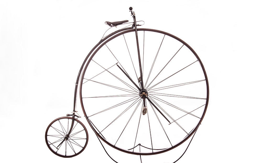 A bicycle with a massive front wheel and a tiny rear wheel