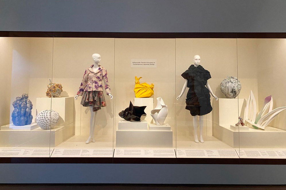 Ceramic and fashion pieces in a wide glass case