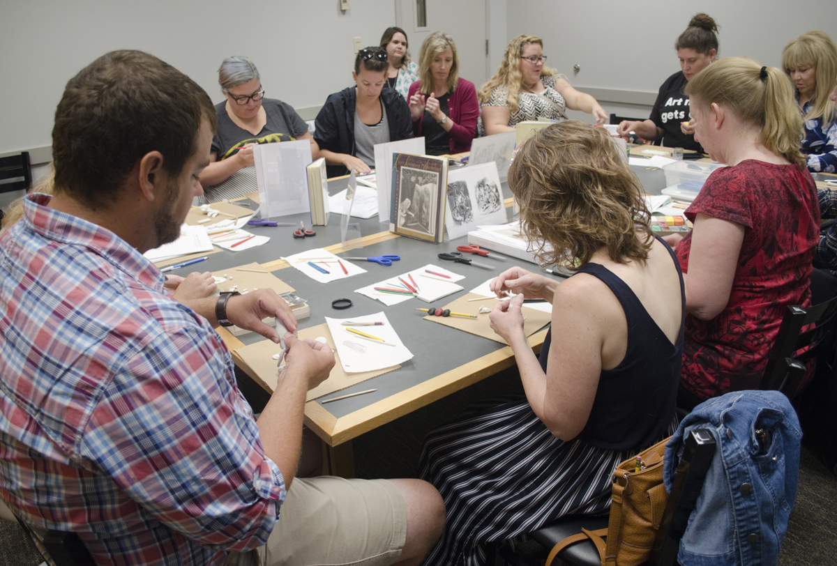 Teachers participate in art activities at the museum
